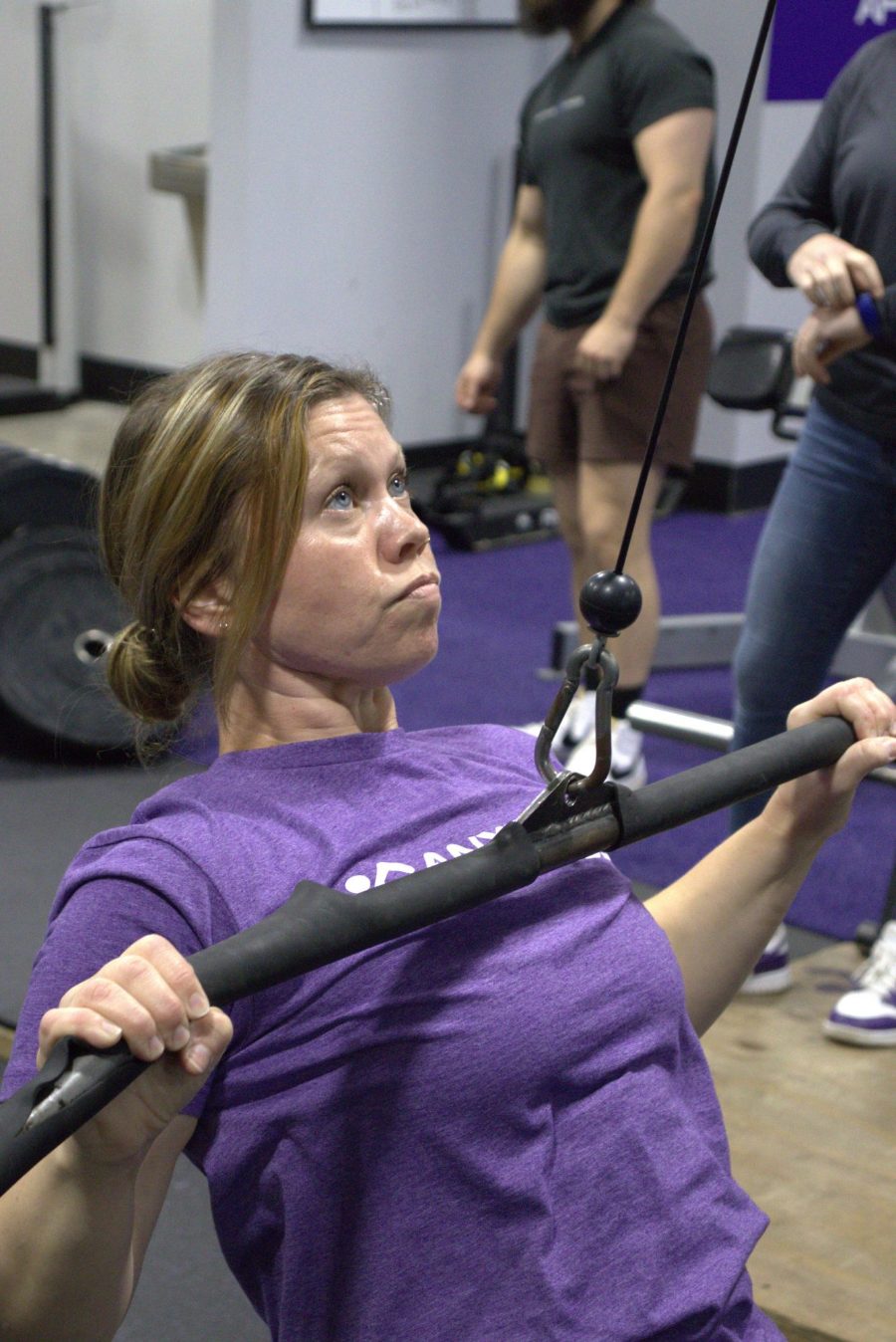 A coach working one-on-one with a member at Anytime Fitness